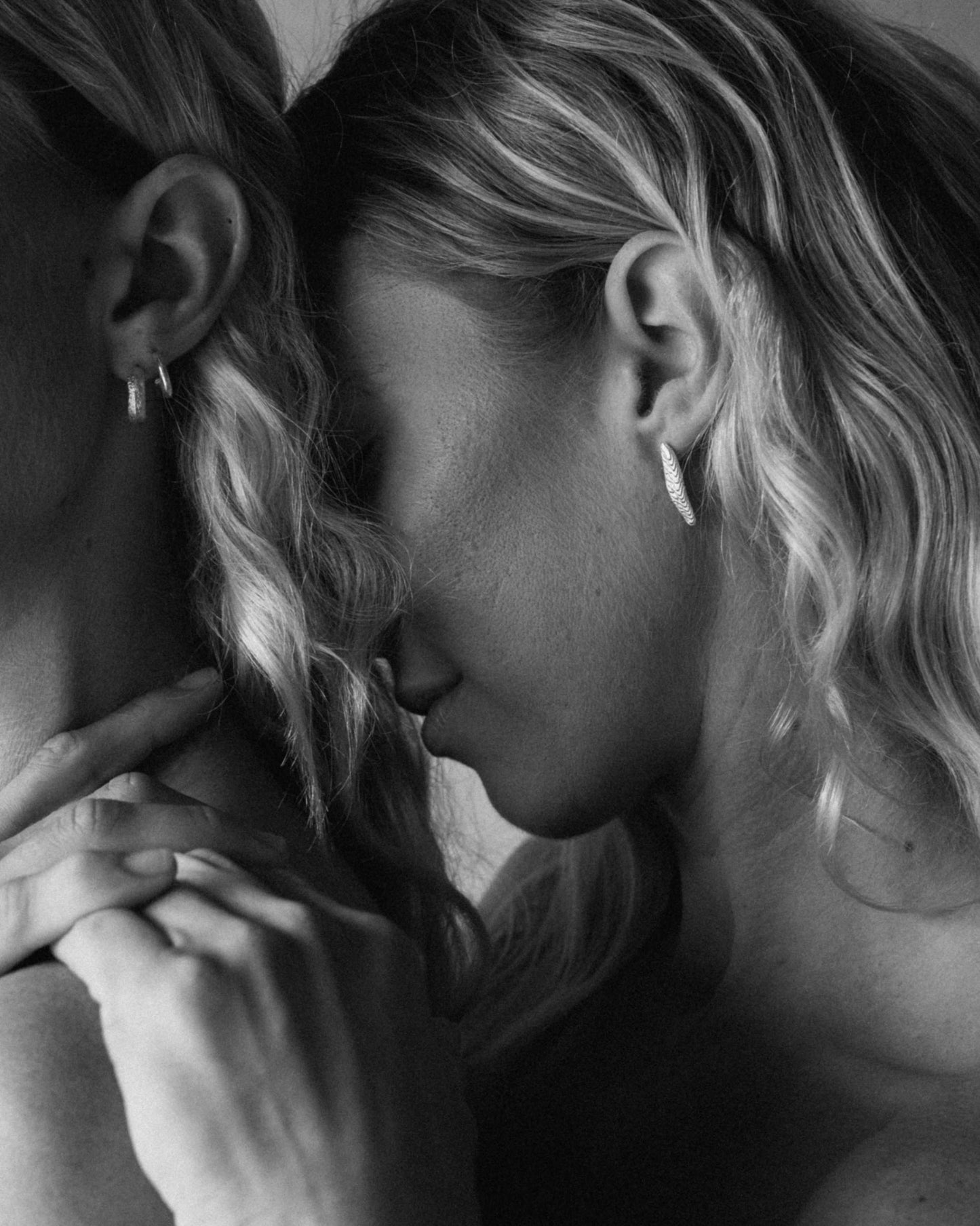 Model shot of long irregular studs with a textured surface worn on ear