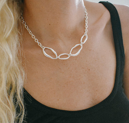 Sterling silver necklace with four organic links connected by a high quality cable chain. Modern architectural design