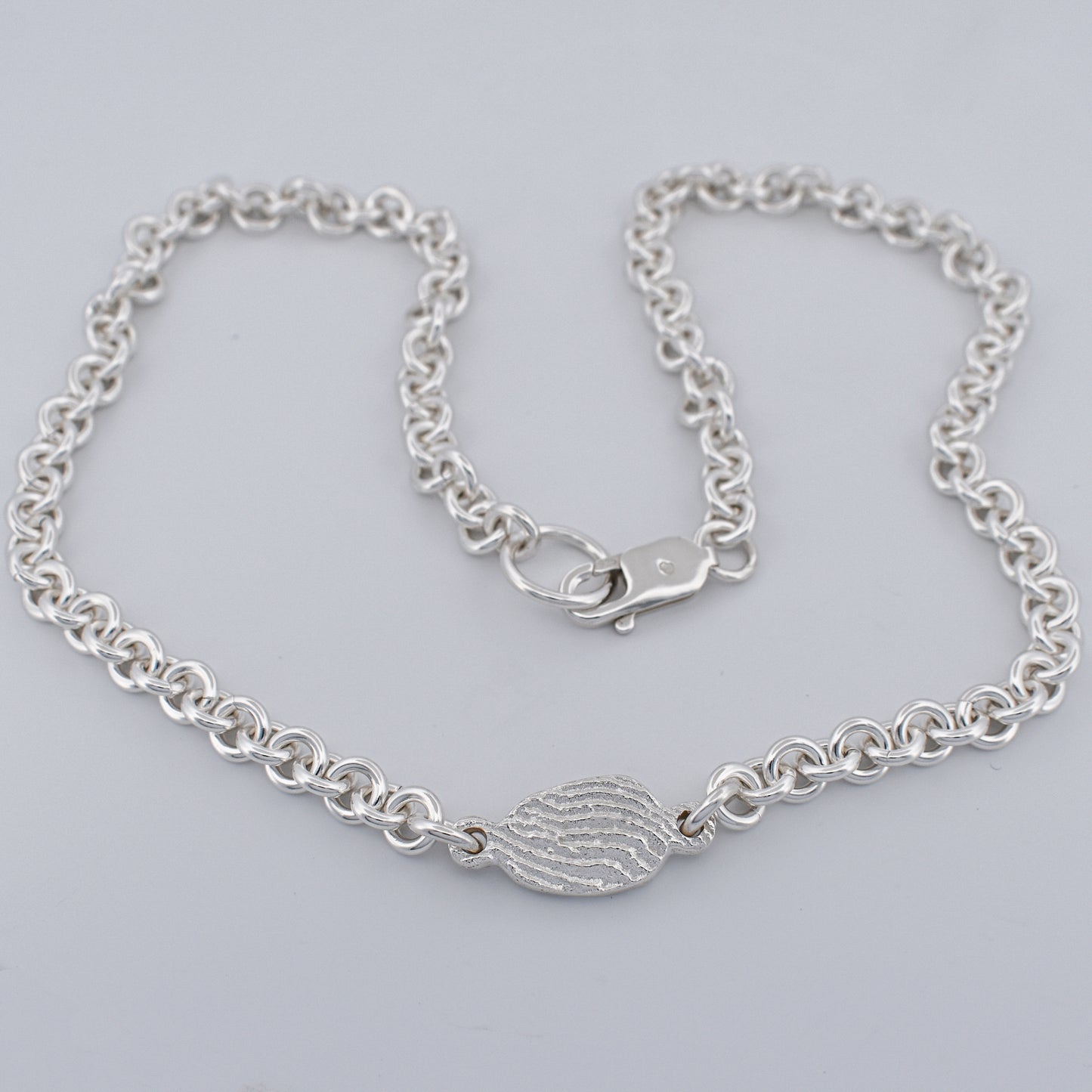 Close up of the tidal tab unisex sterling silver belcher chain necklace