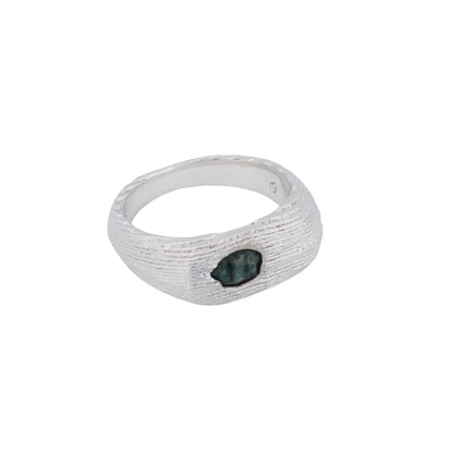 Product shot of a cuttlefish cast oval signet ring with a rose-cut emerald