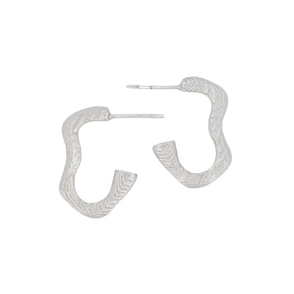 Sterling silver hoop earrings with a textured squiggle design, created using cuttlefish-cast technique, displayed on a plain background